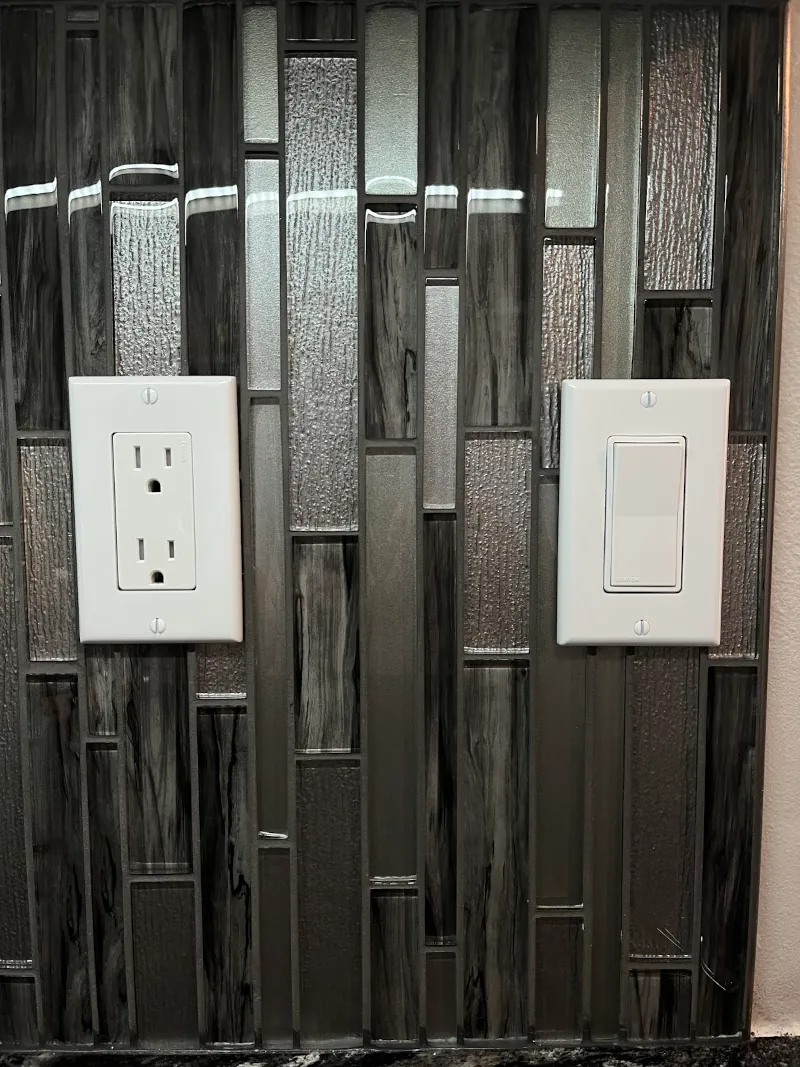Close-up of new residential electrical outlet installed in a kitchen backsplash