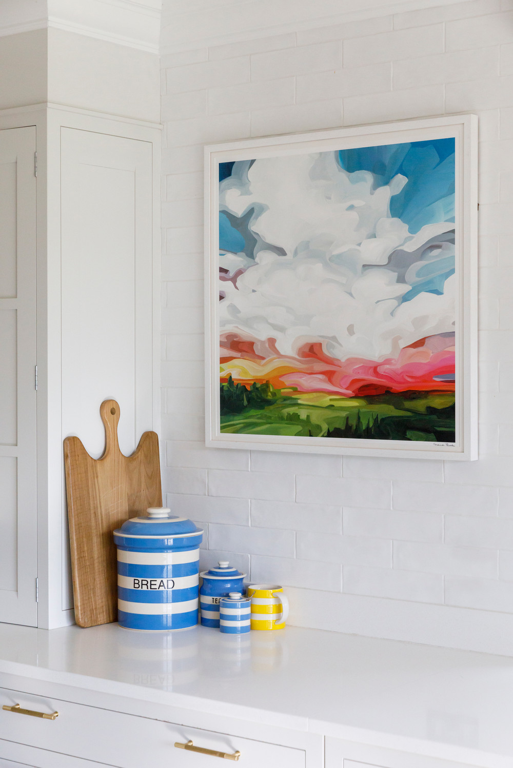 Soft blue Shaker kitchen cabinetry with brass hardware in a coastal kitchen by Lorna Smith Interiors