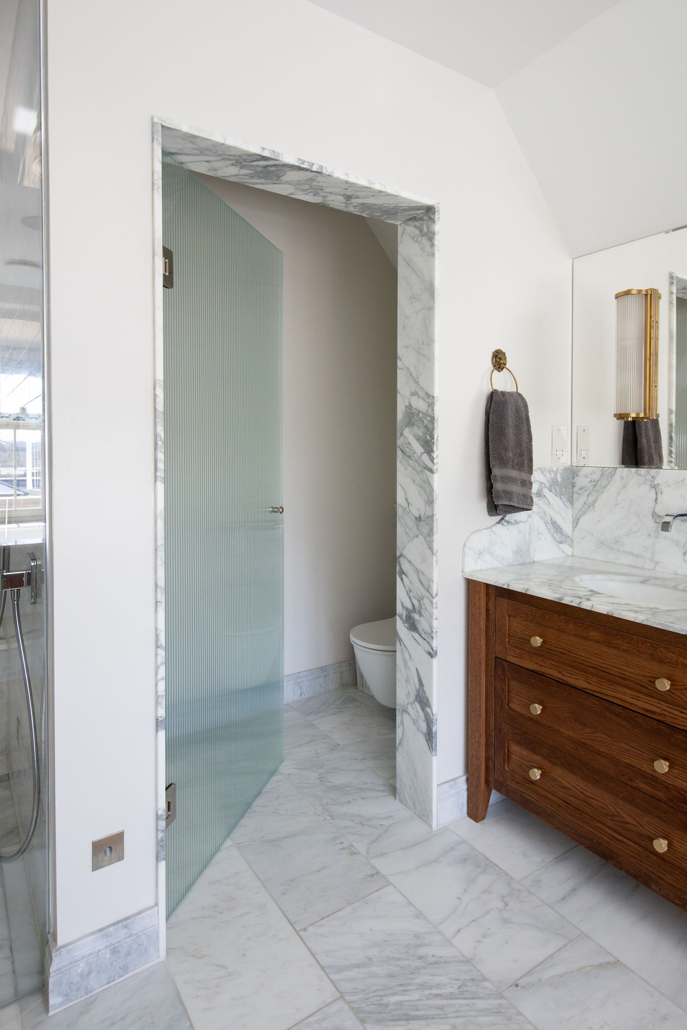 Warm wood and marble en-suite bathroom detail — Lorna Smith Interiors, West Sussex