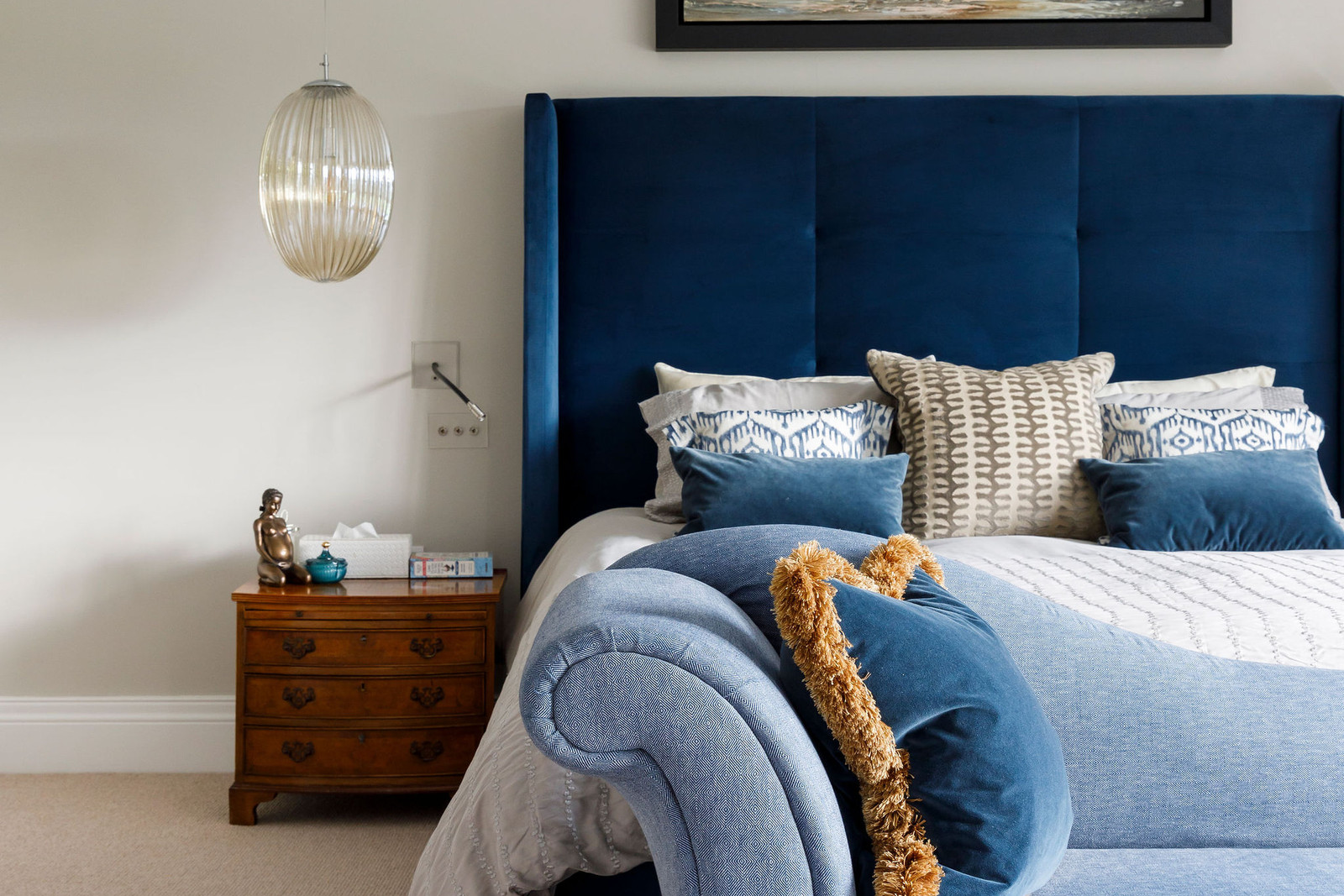 Understated blue master bedroom with layered neutral textures — Lorna Smith Interiors, Hampshire