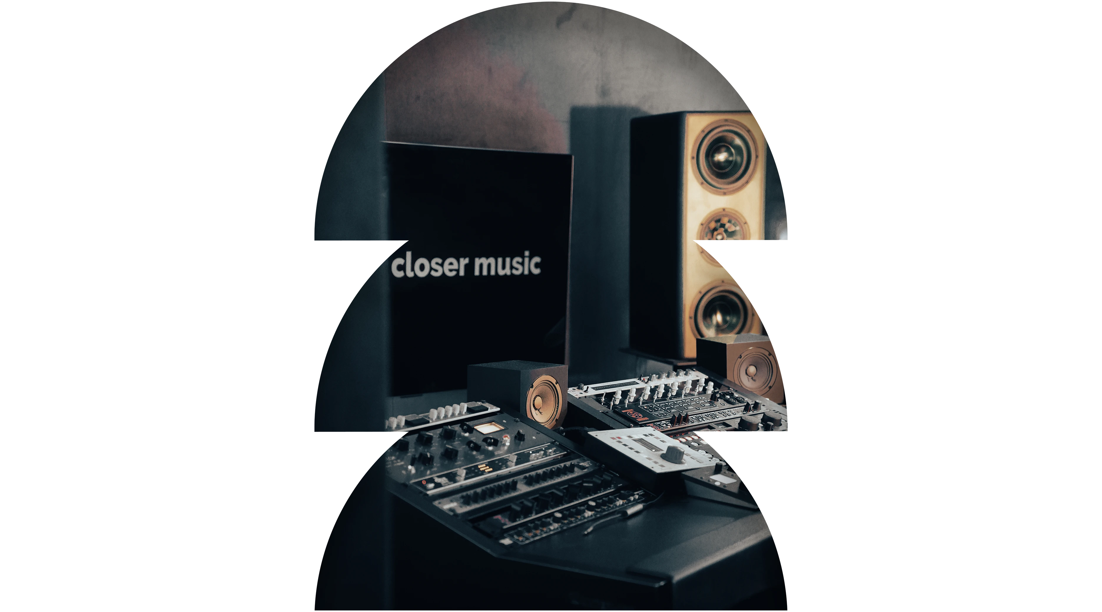 Recording studio mixing console with speakers and screen showing 'closer music' text.