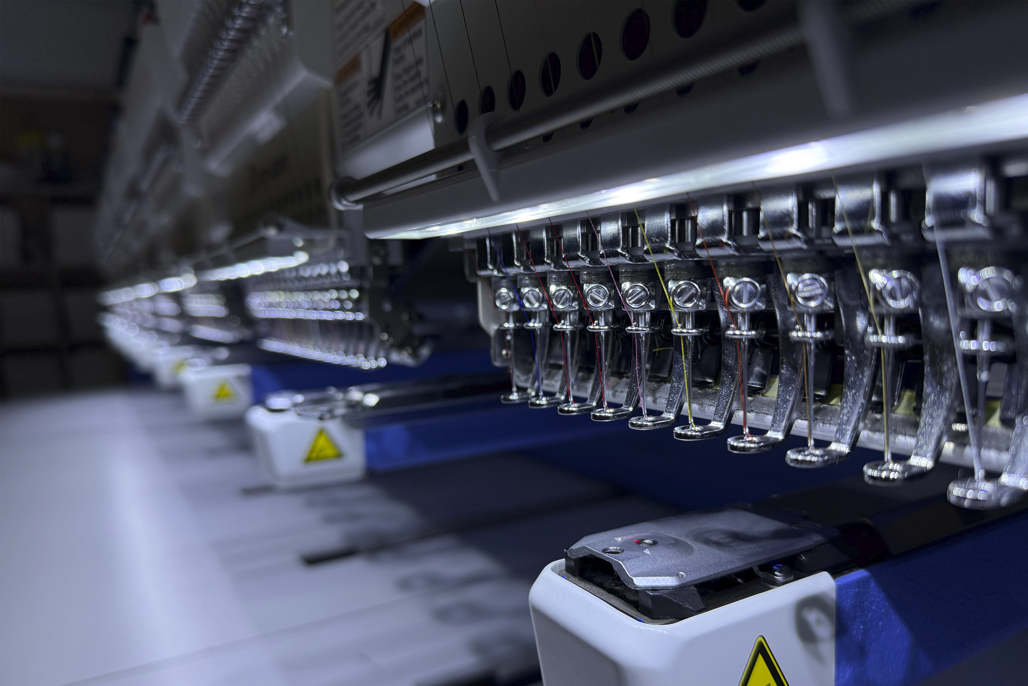 Commercial embroidery machines producing branded workwear for UK businesses
