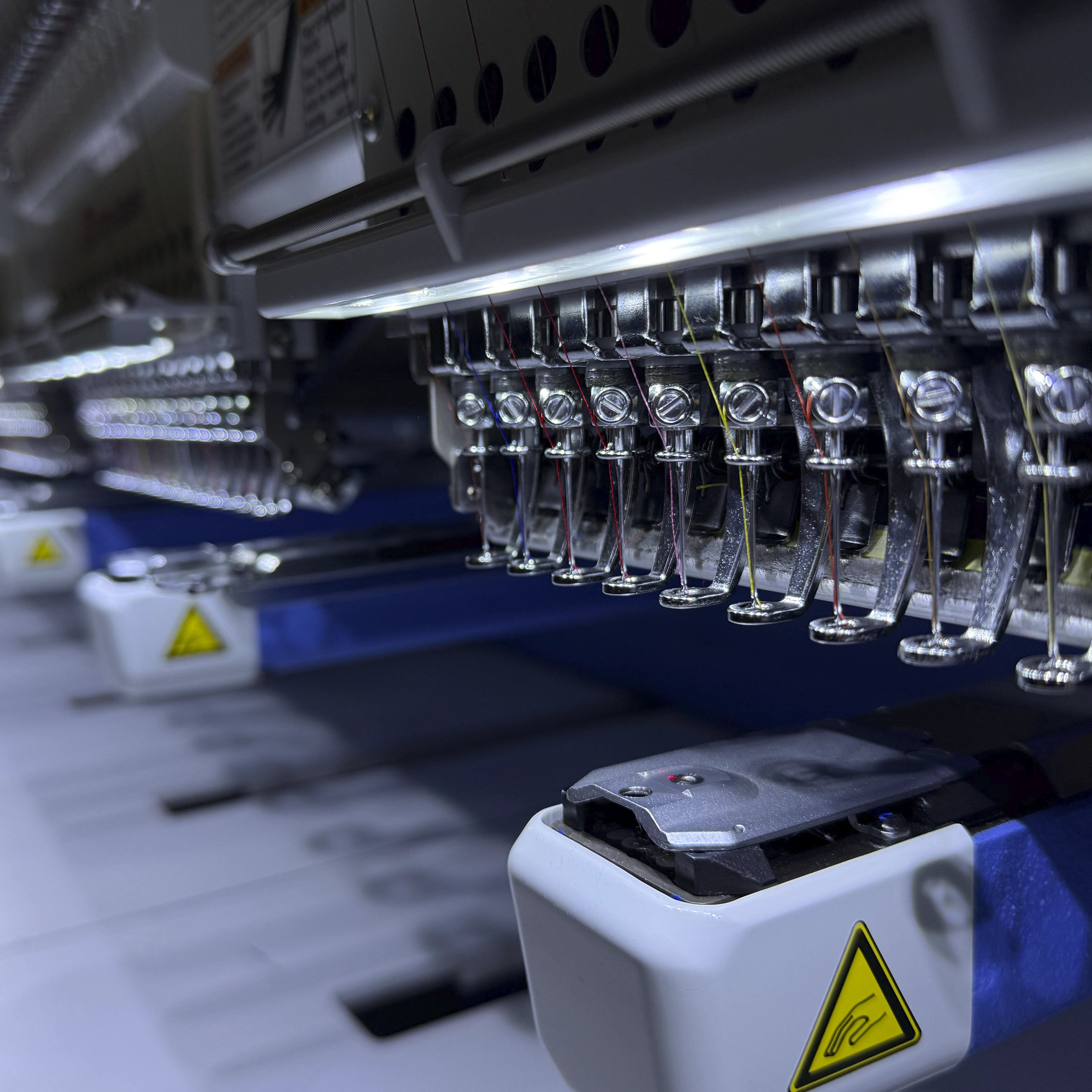 Commercial embroidery machines producing branded workwear for UK businesses