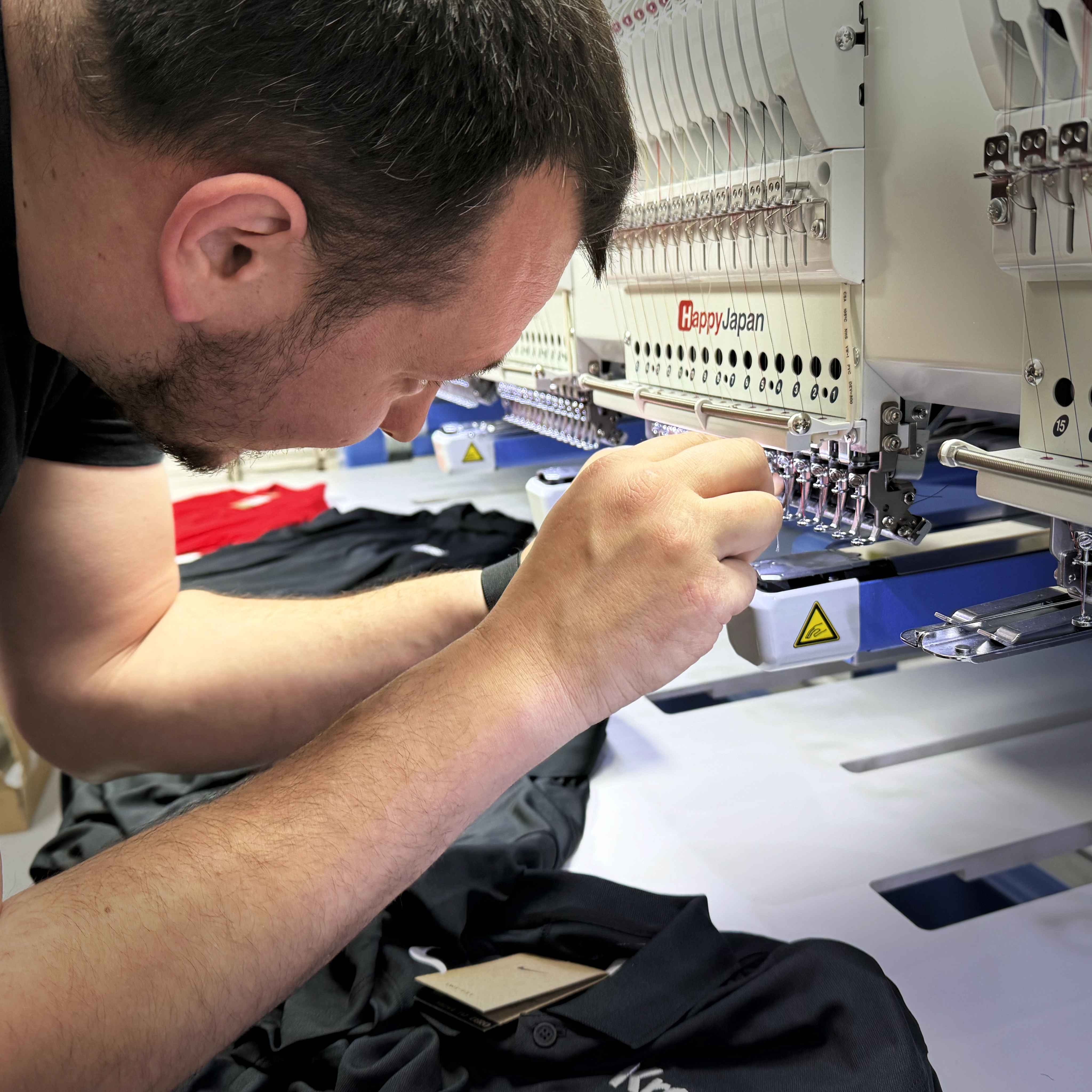 Embroidery thread setup for custom corporate workwear production