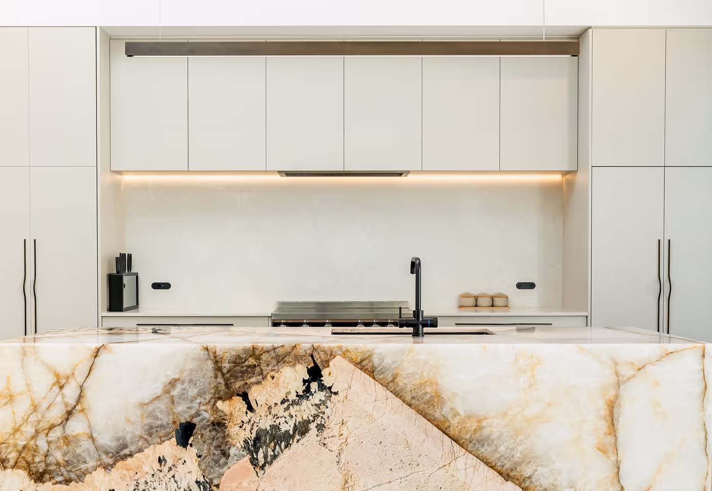 Interior of a kitchen with white cabinets.