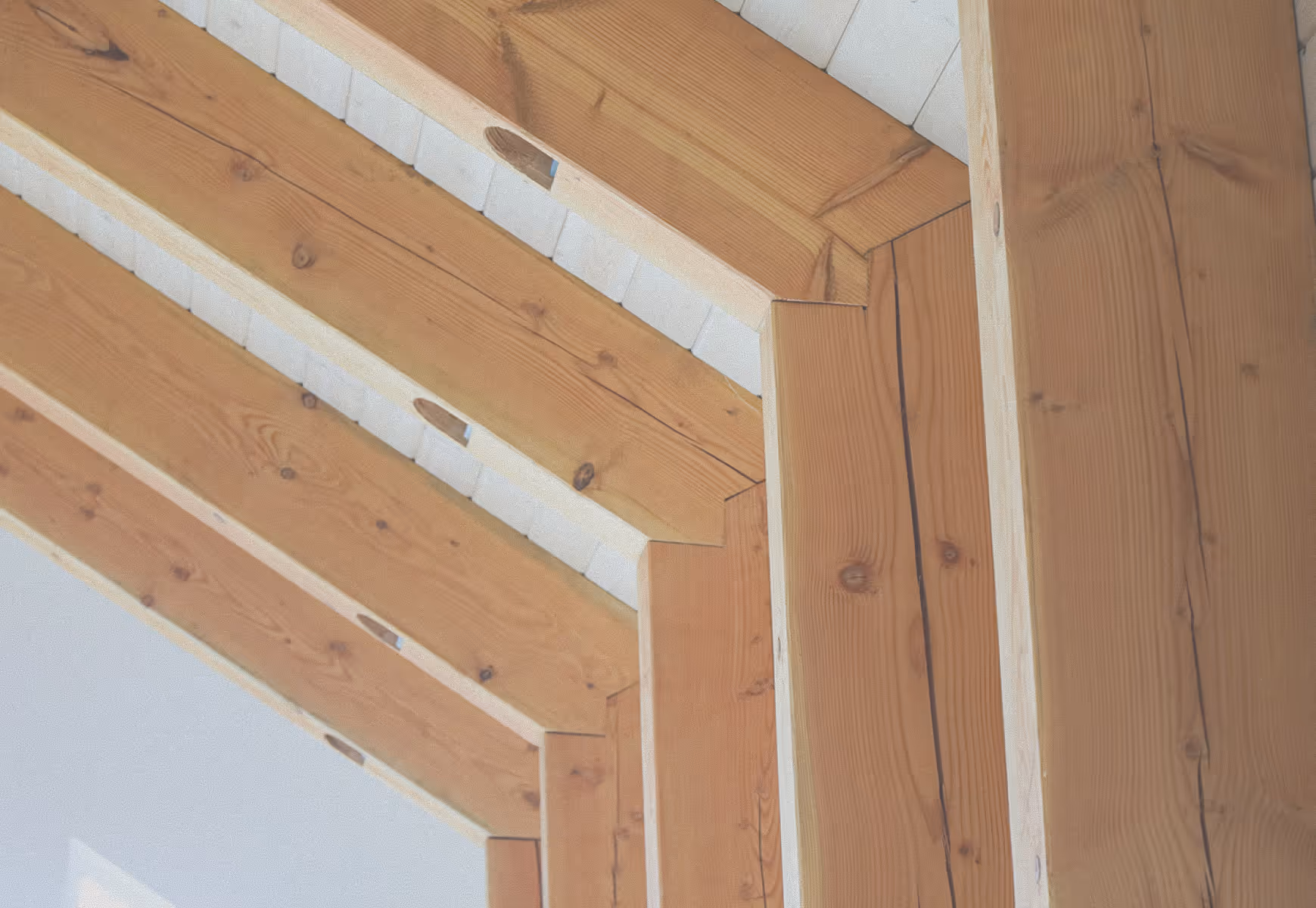 Wood beams installed in a house by Facet Custom Builders.