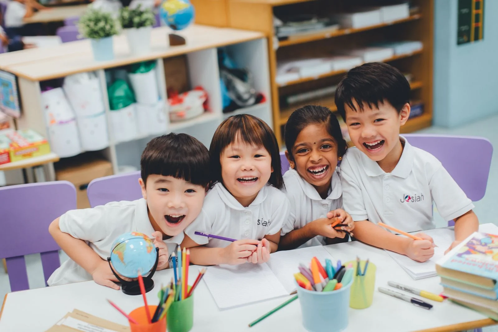 A K2 child mid-laugh during a classroom moment.