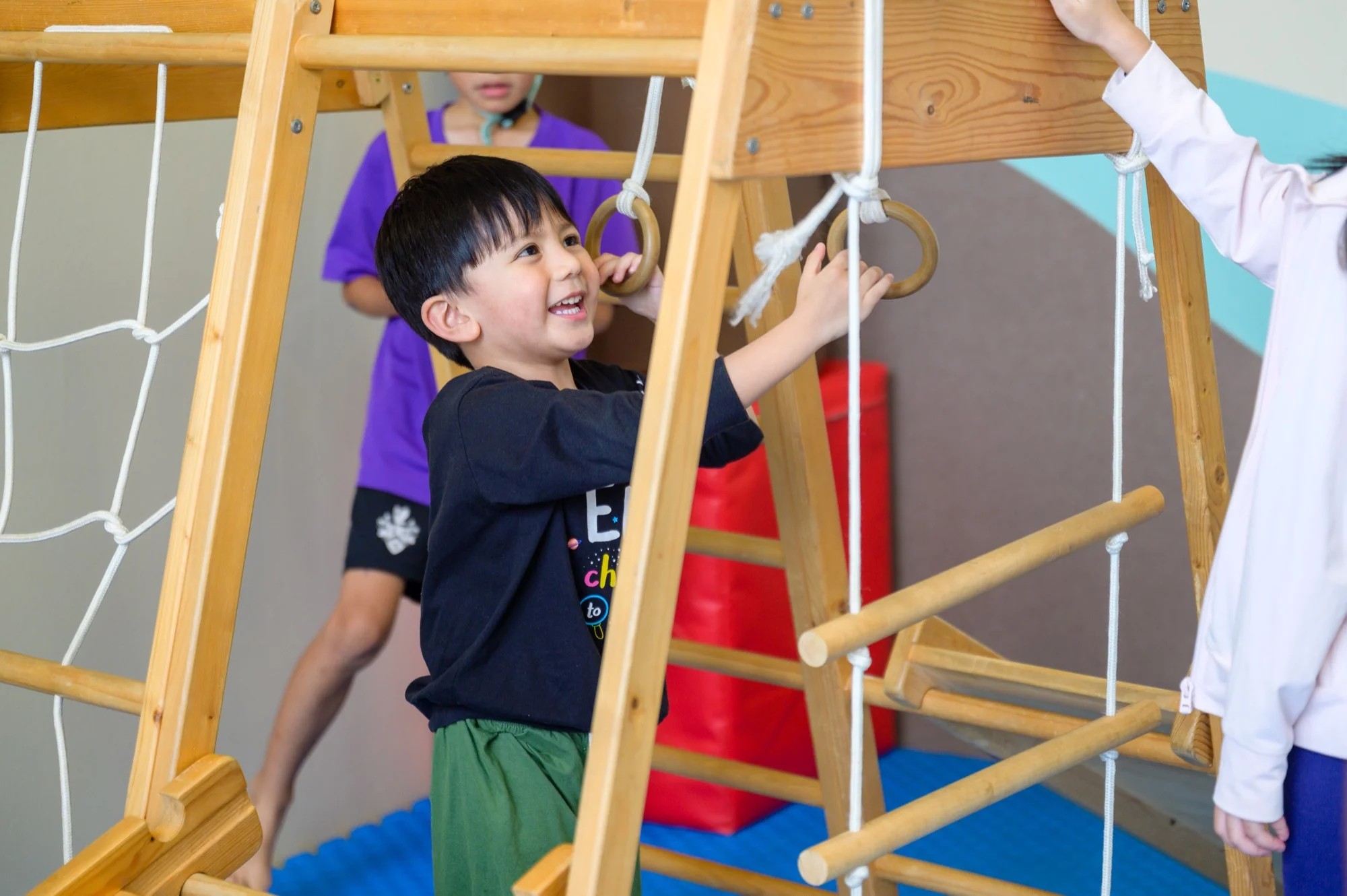 A Josiah child mid-work at a Montessori material.