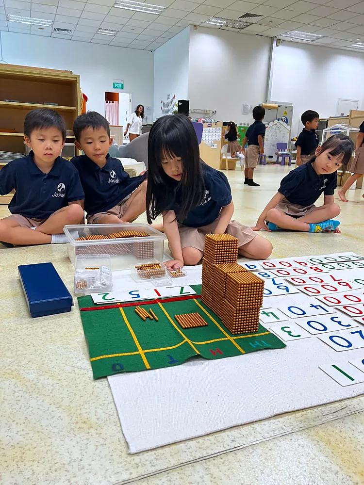 Nursery and Kindergarten children at work with Montessori materials.