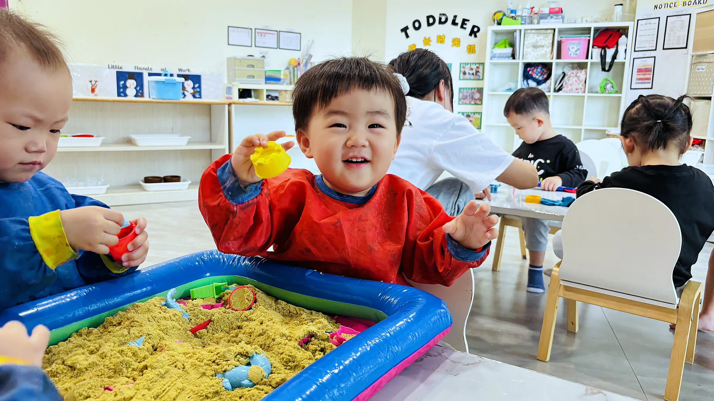 Toddlers exploring hands-on sensorial play at Josiah.