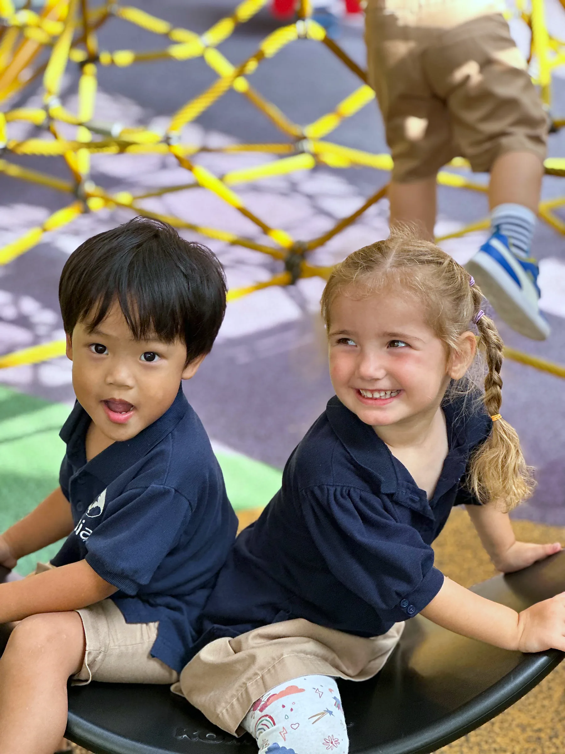 Two Josiah children playing on the centre's outdoor equipment.