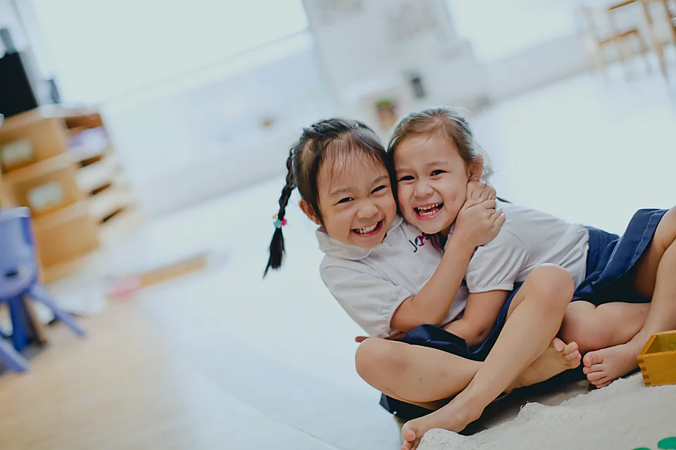 Two Josiah children sharing a joyful moment together.