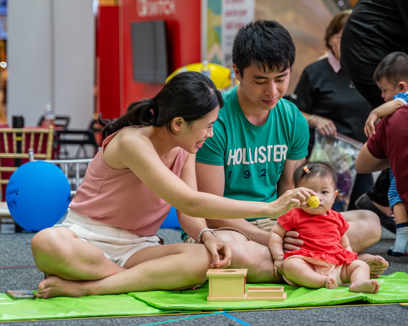 A parent and baby exploring sensory materials together in Baby Montessori