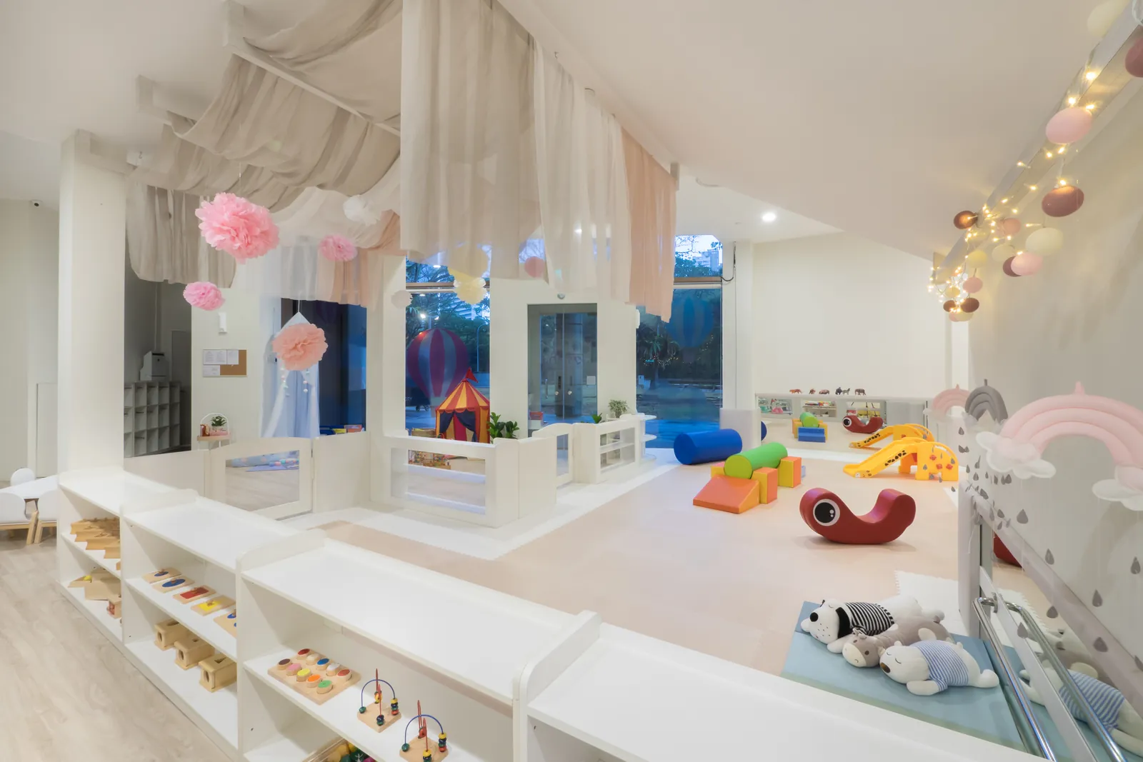 A soft, curtained infant room at Josiah Montessori Suntec City.