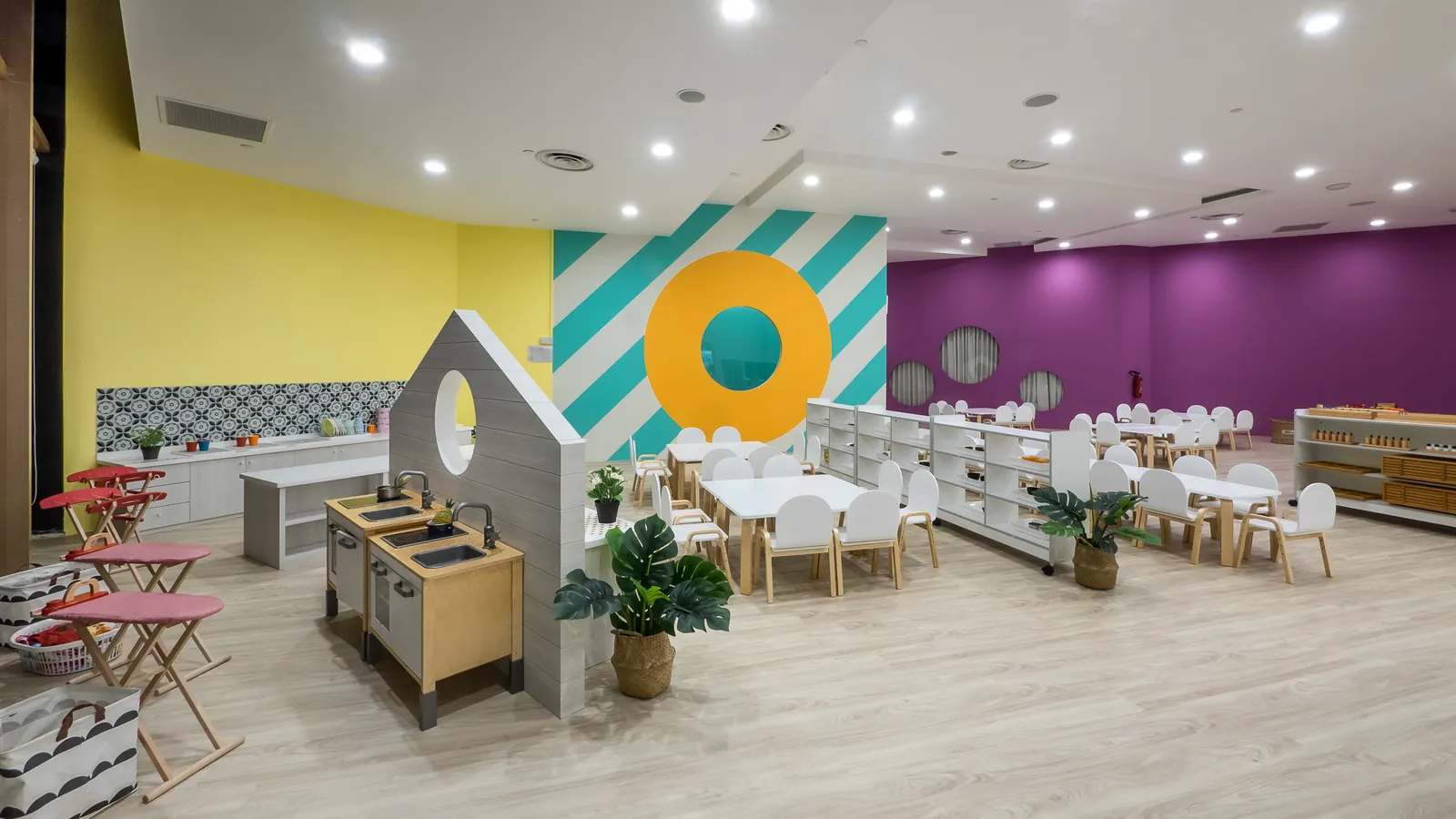 A classroom at Suntec City with the home corner and open shelves.
