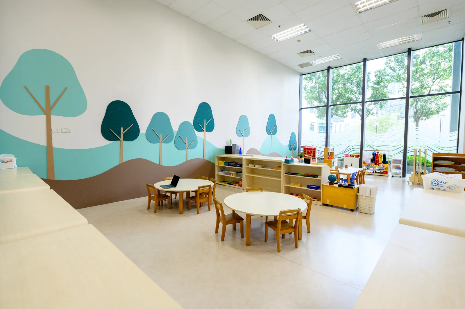 A classroom at Josiah Montessori Aperia, with full-length glass along one wall.