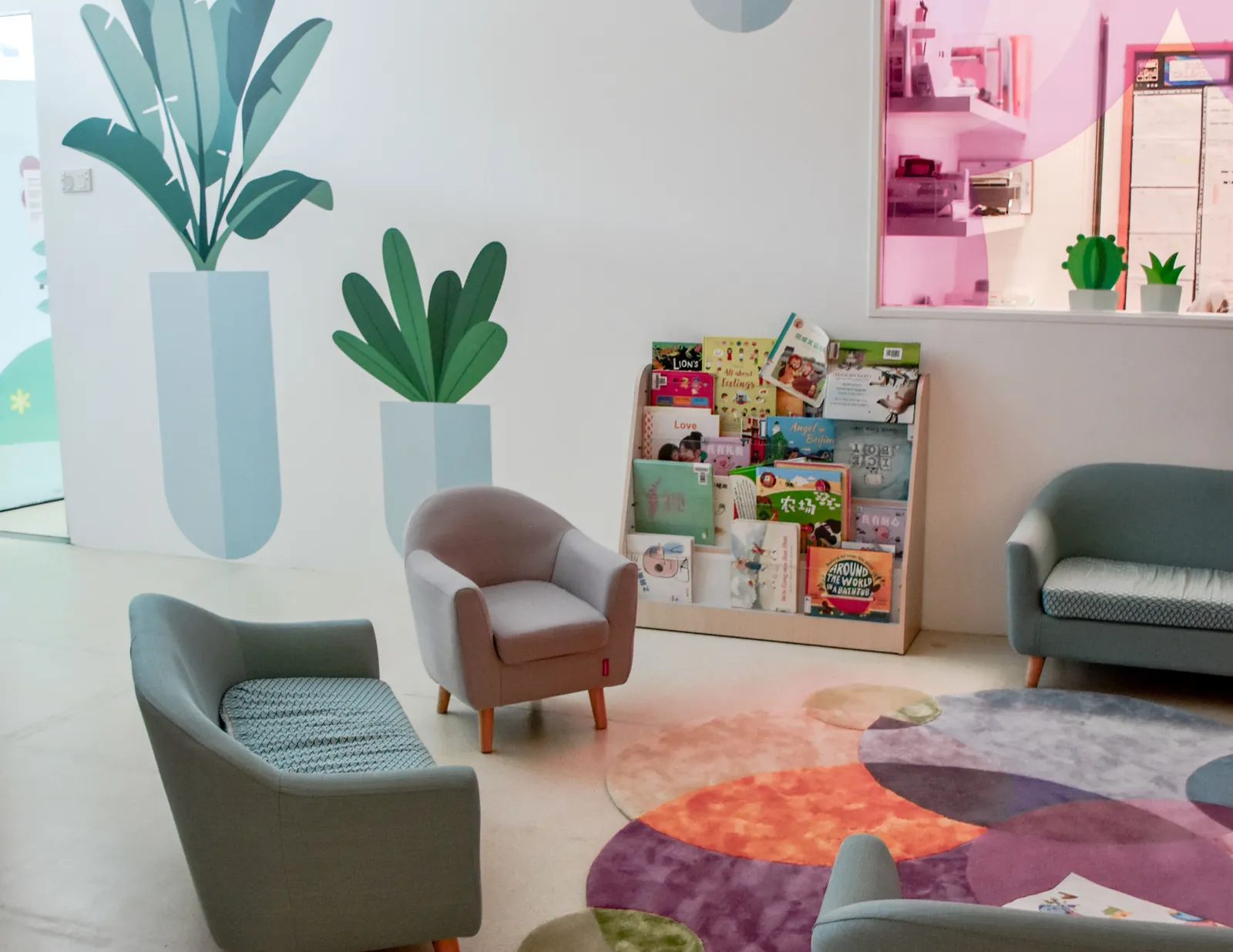 The reading corner at Changi Business Park, with the book display and soft seating.
