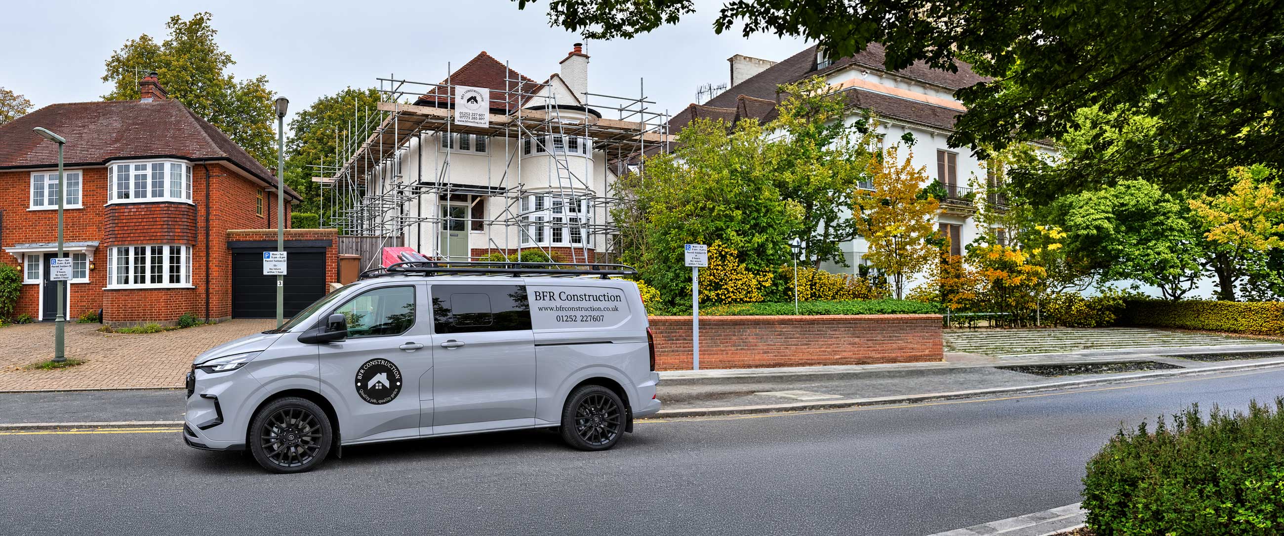 BFR Construction van parked outside a residential home renovation project with scaffolding, showcasing professional construction and property renovation services in Surrey and Hampshire.
