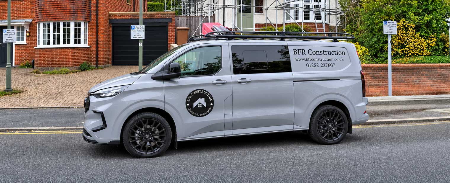 BFR Construction van parked outside a residential property renovation project with scaffolding, highlighting professional construction and home improvement services.