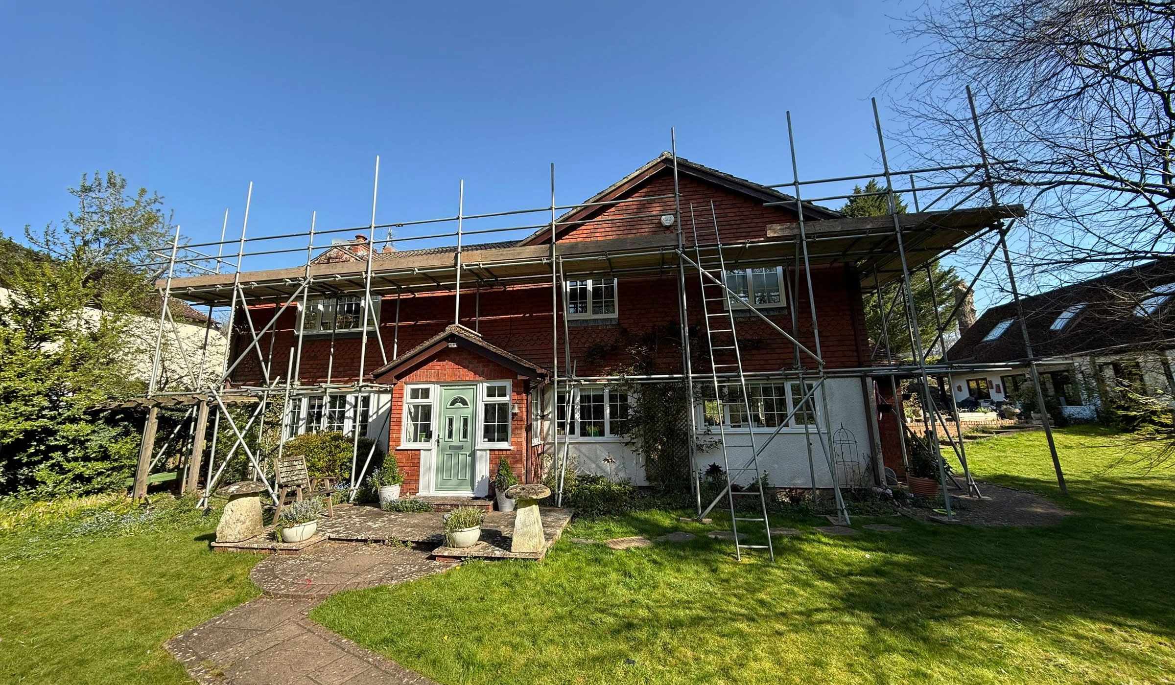 Residential property under renovation with scaffolding installed around the exterior for construction and home improvement work by BFR Construction.