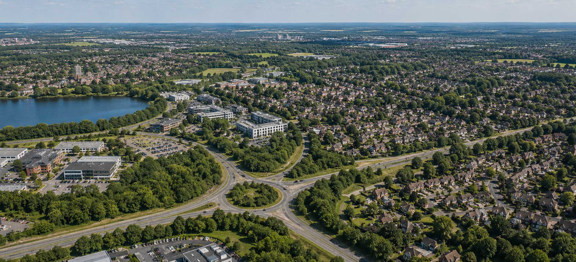 Aerial view of residential communities across Surrey, Hampshire and Berkshire showing local homes, green spaces and transport links within BFR Construction’s service area.
