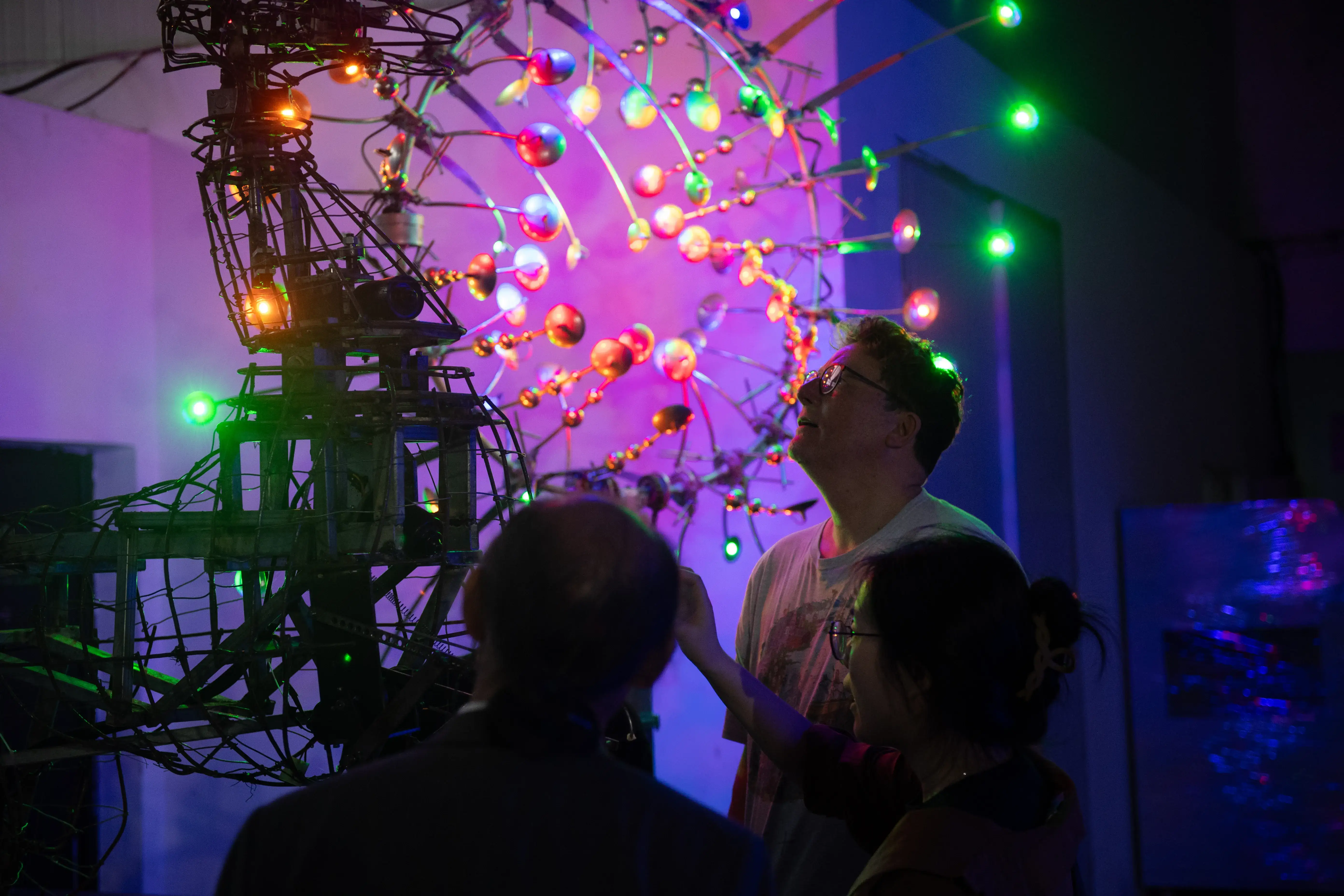 Visitors and fabricators discussing an artwork and its production requirements.