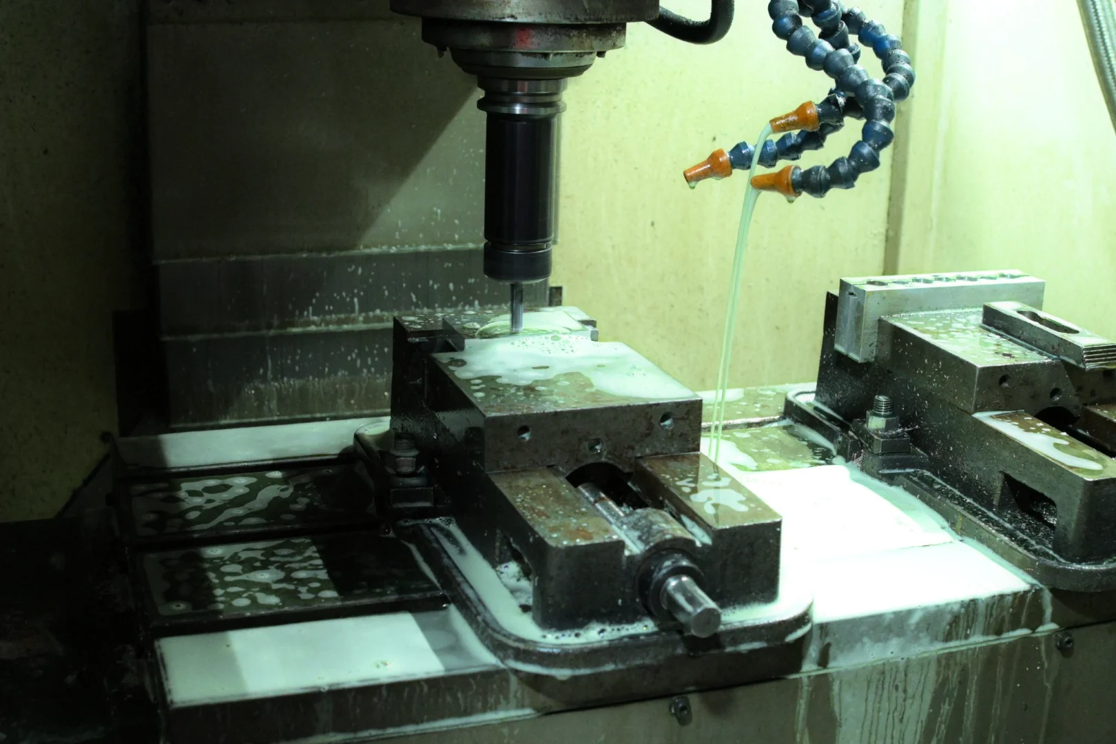 CNC machining metal mould components inside a machining enclosure