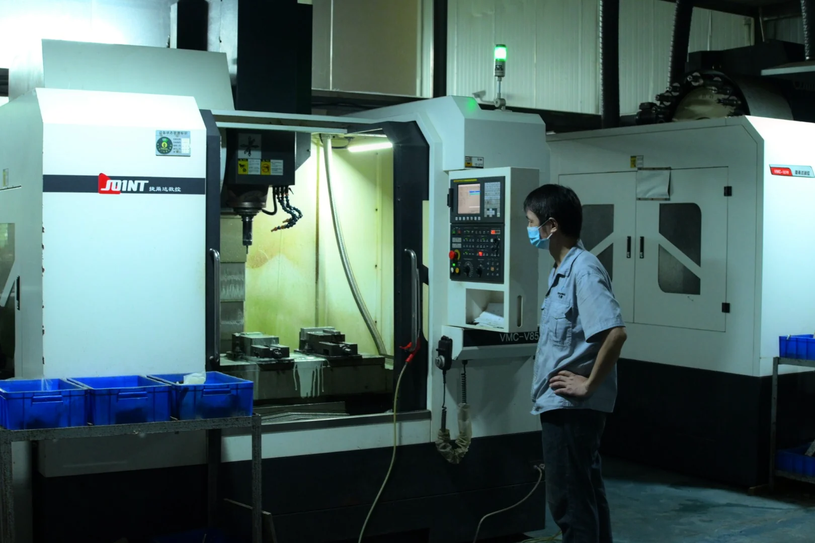 CNC machining equipment and operator in a production workshop