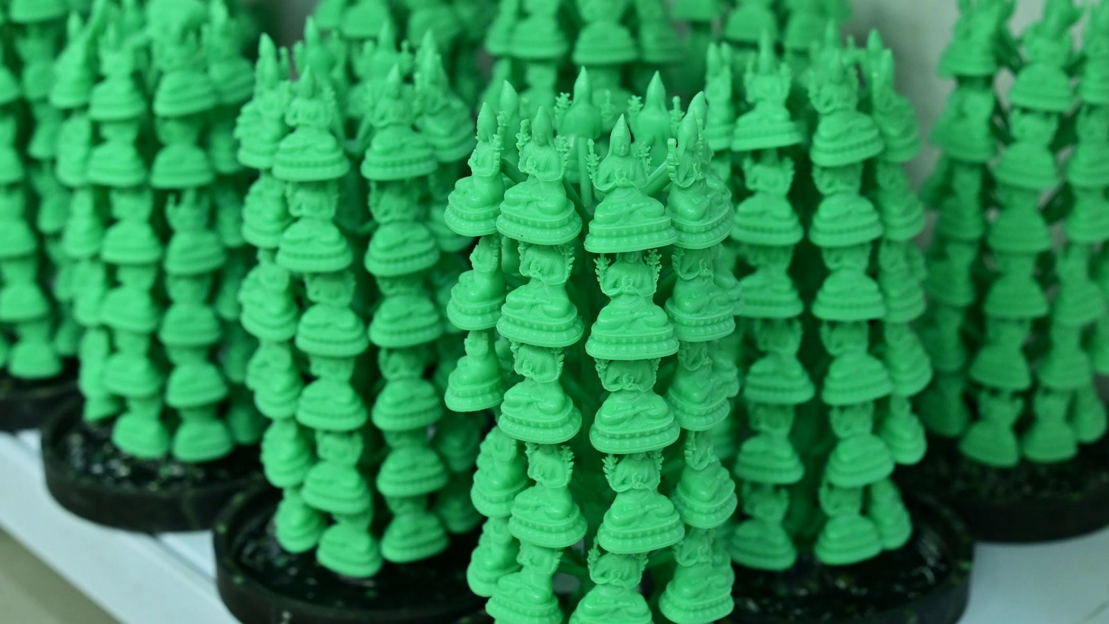 Small figurative wax patterns arranged on casting trees.