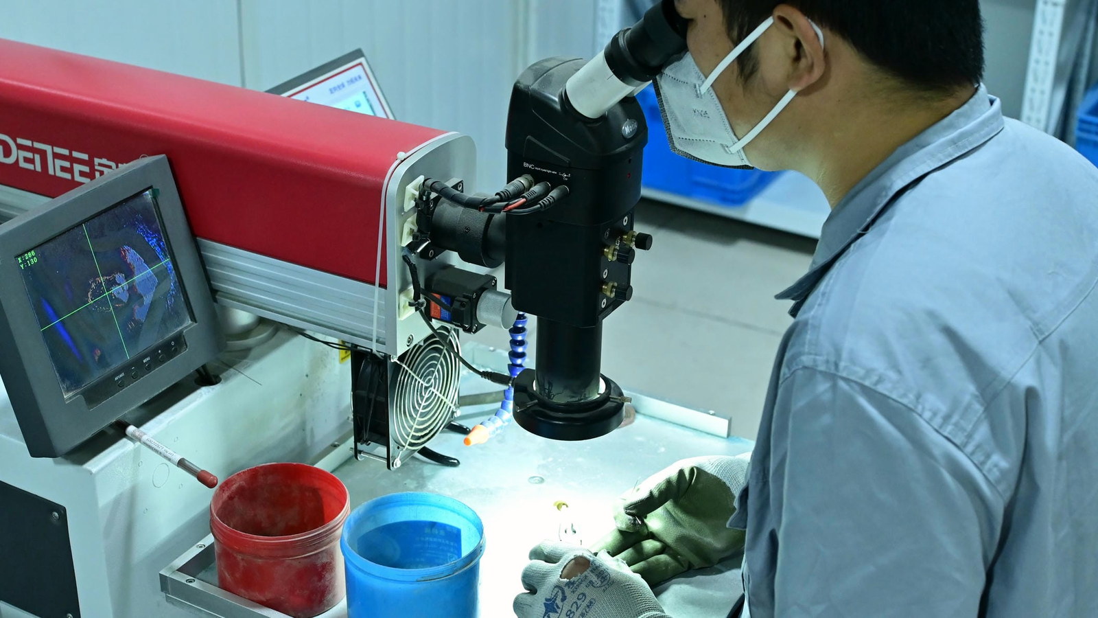 A craftsperson carrying out fine welding under magnification.