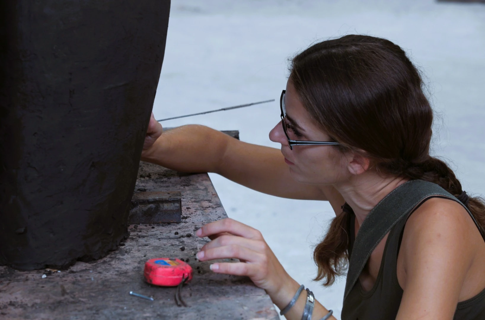 An artist works on a sculpture model.