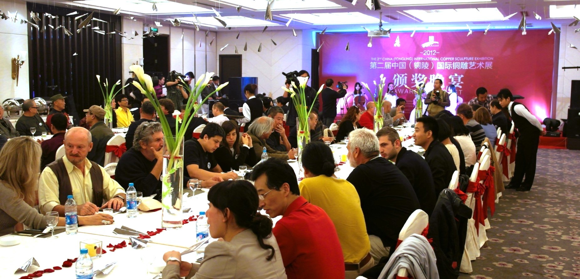 Guests seated at banquet tables during the symposium.