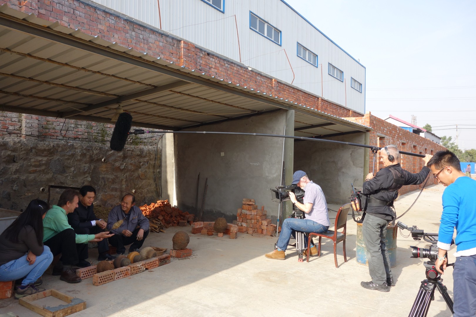 A wide view of the interview and filming setup outside the workshop.