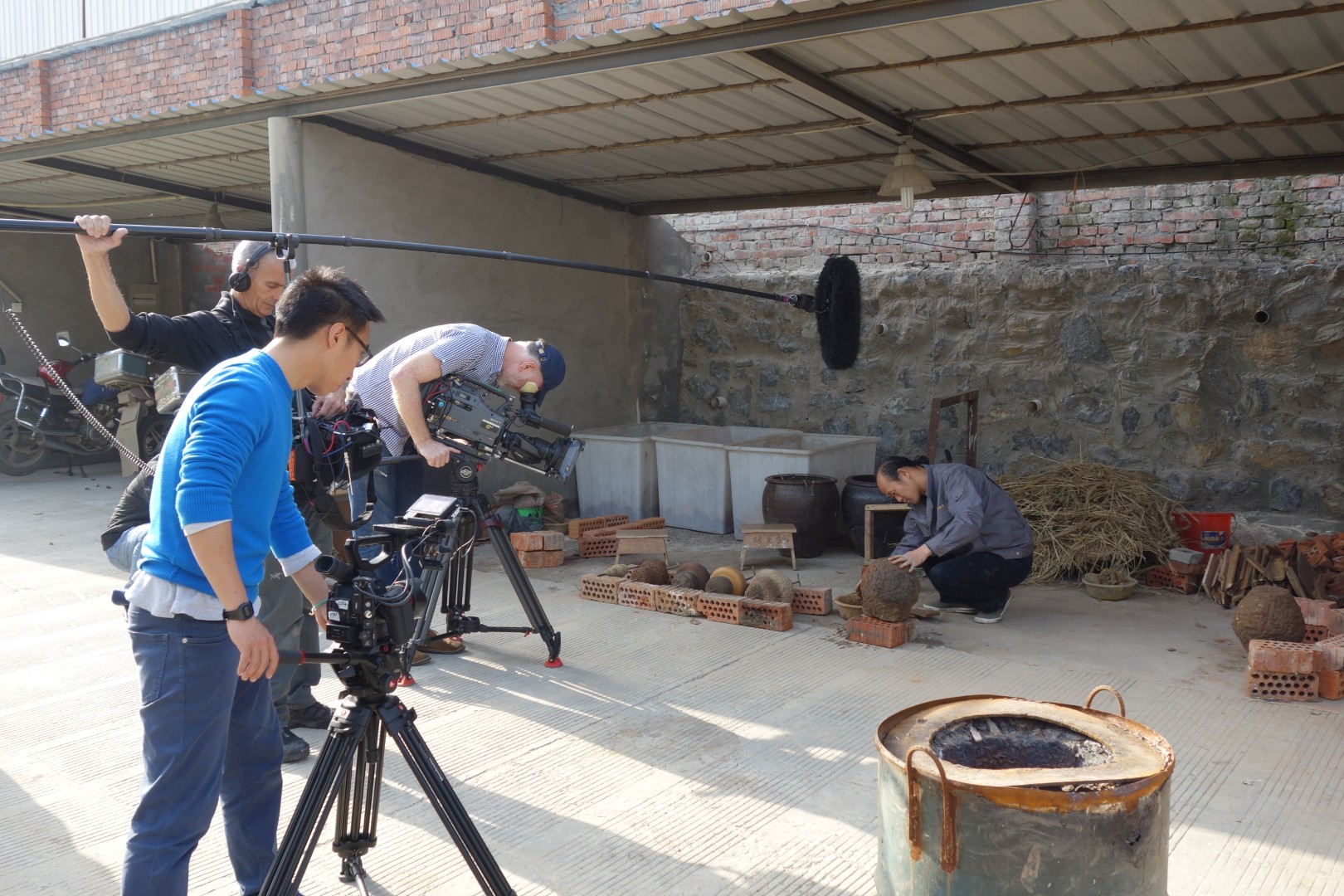 Camera operators and a boom microphone recording the workshop demonstration.