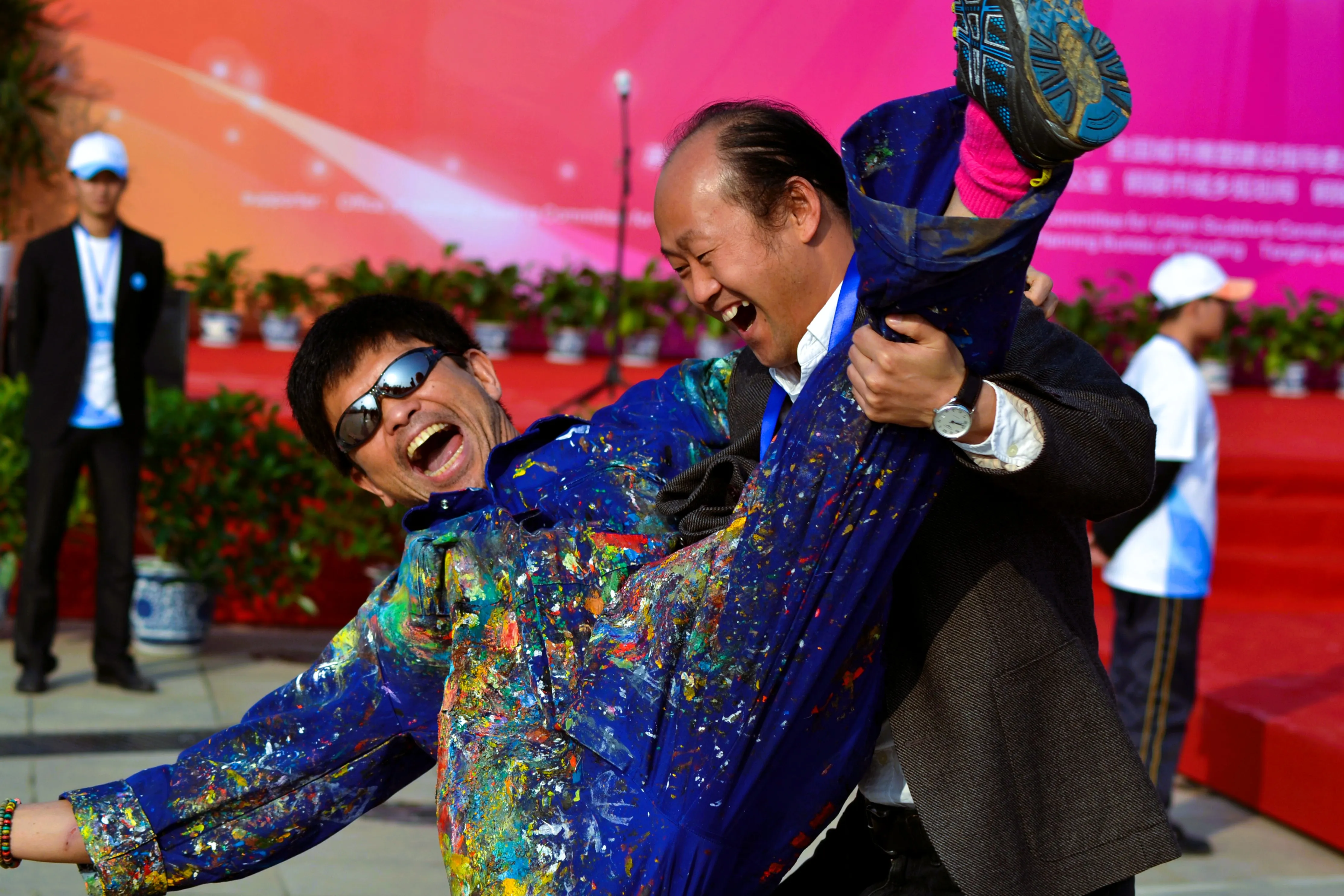 Two participants sharing a light-hearted moment at an outdoor event.