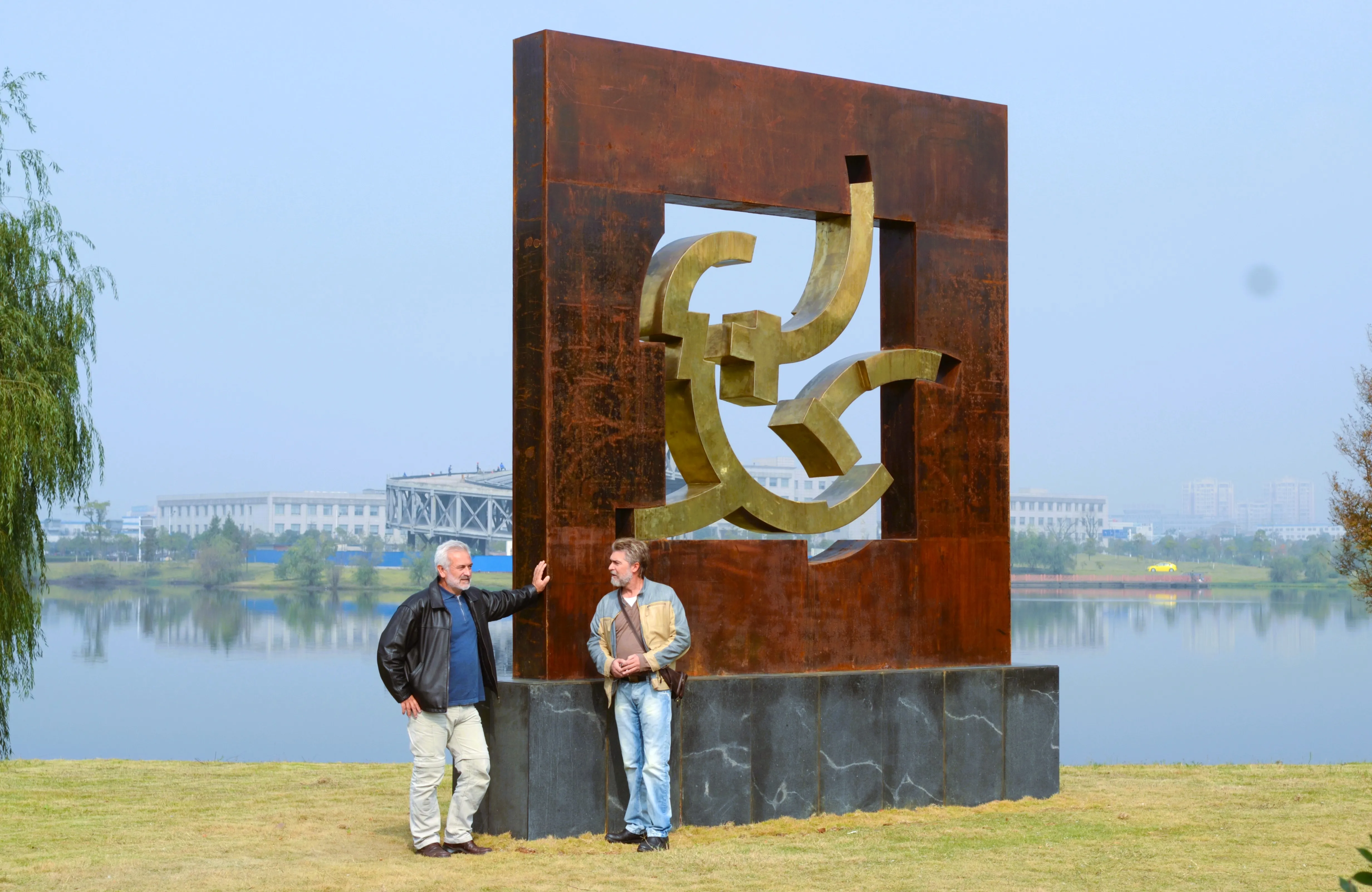 The Remoteness beside the lake, with two people showing its scale.