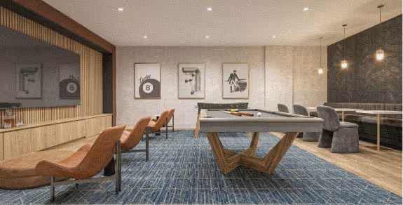 Modern game room with a pool table, bar stools, orange chairs, blue carpet, and framed artwork on walls.