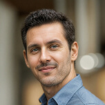 headshot of man with brown hair
