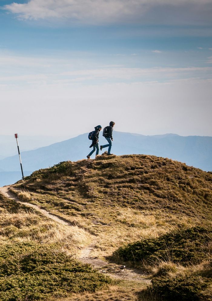 Couple hiking together on a ridge in western Serbia