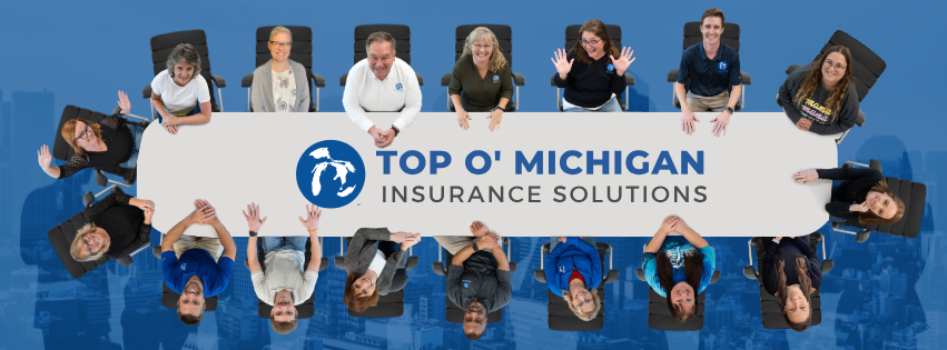 The Top O' Michigan Insurance Solutions team gathered around a conference table