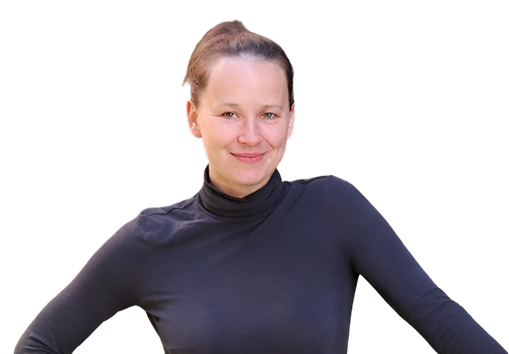Smiling woman with a bun wearing a black turtleneck and posing with arms out.