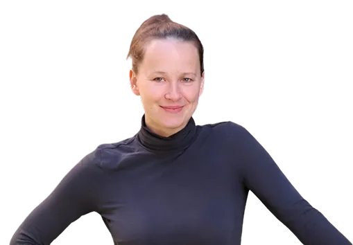 Smiling woman with a bun wearing a black turtleneck and posing with arms out.