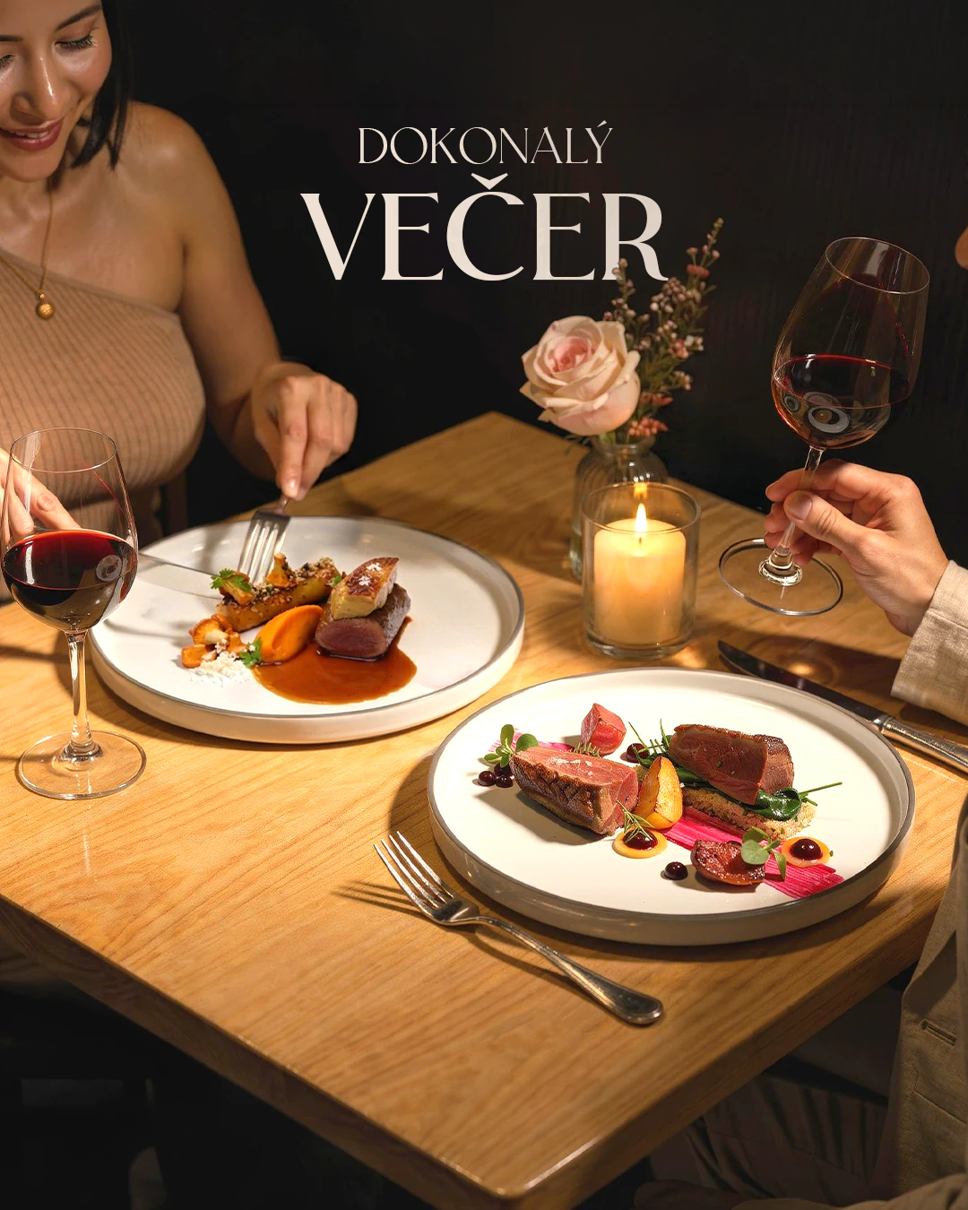 Grand Cru fine dining dinner table with plated dishes, red wine and candlelight