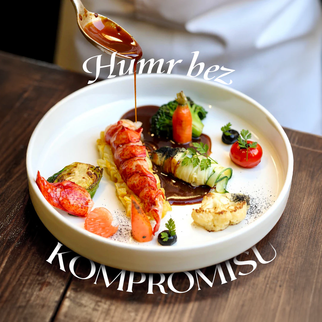 Grand Cru seafood dish with lobster, vegetables and sauce being poured