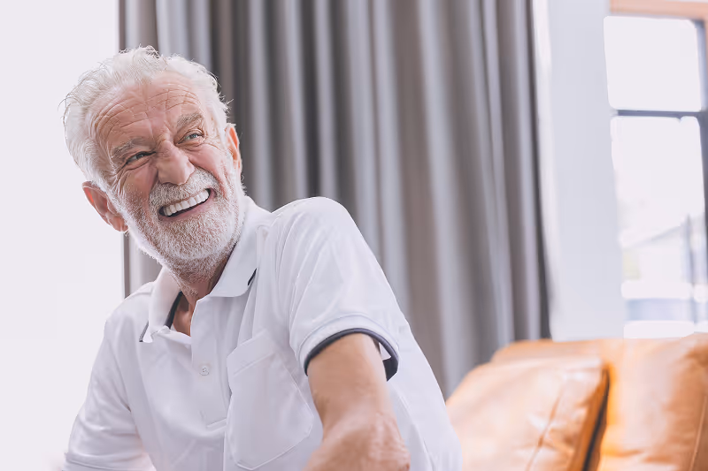 Patient smiling after zygomatic implant transformation at Arvada Dental Center & Implants in Arvada, CO