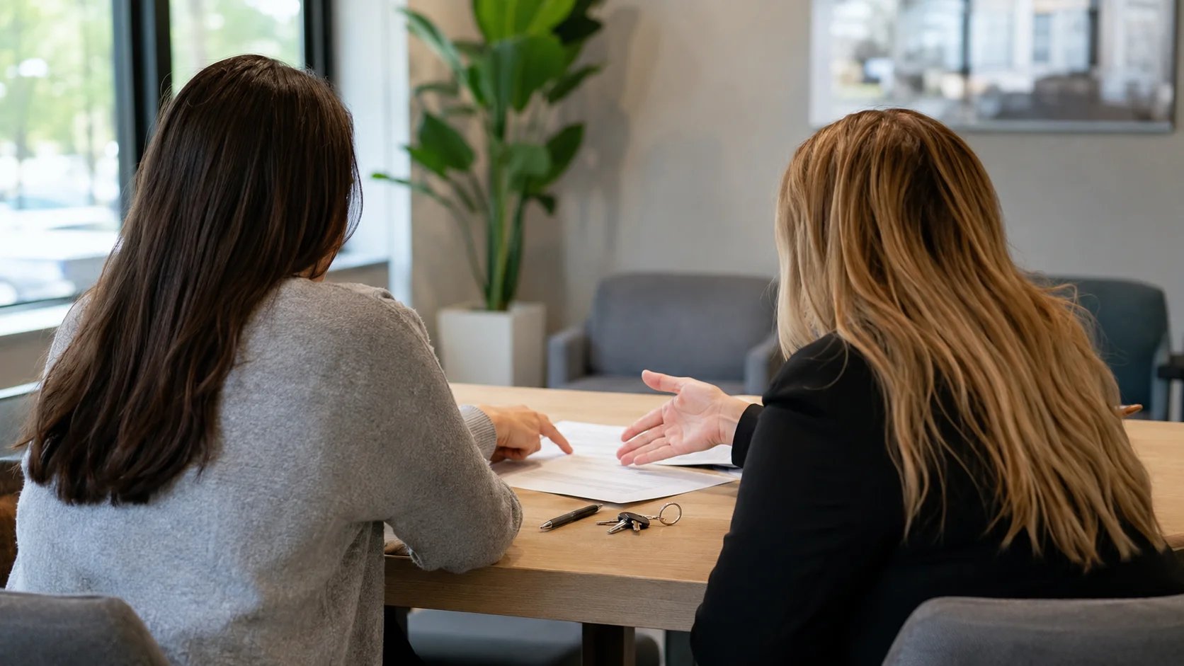 Prospective renters meeting with a leasing agent during an apartment search