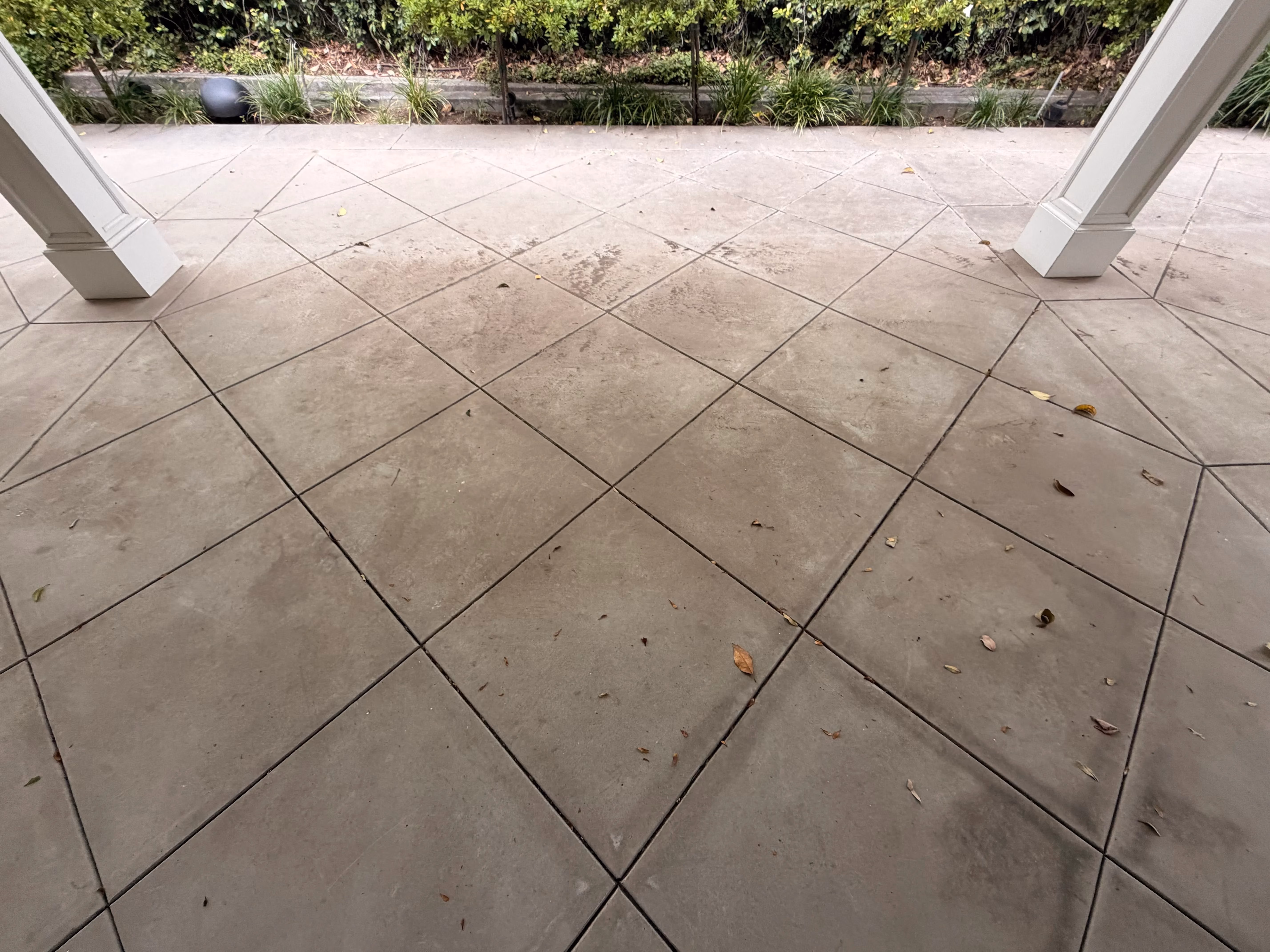 Dirty concrete driveway before pressure washing in Pasadena