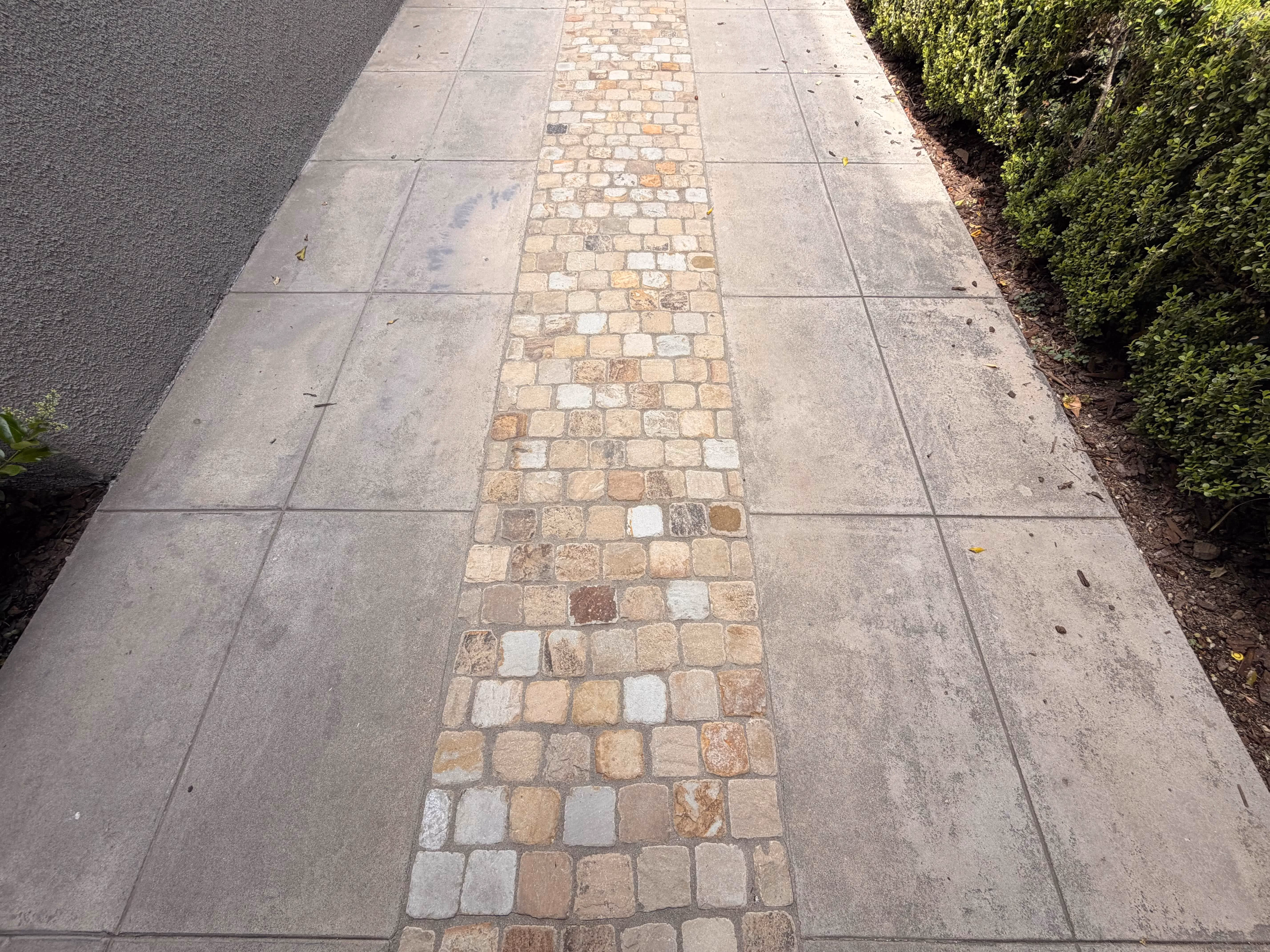 Dirty stone paver walkway before pressure washing in Pasadena