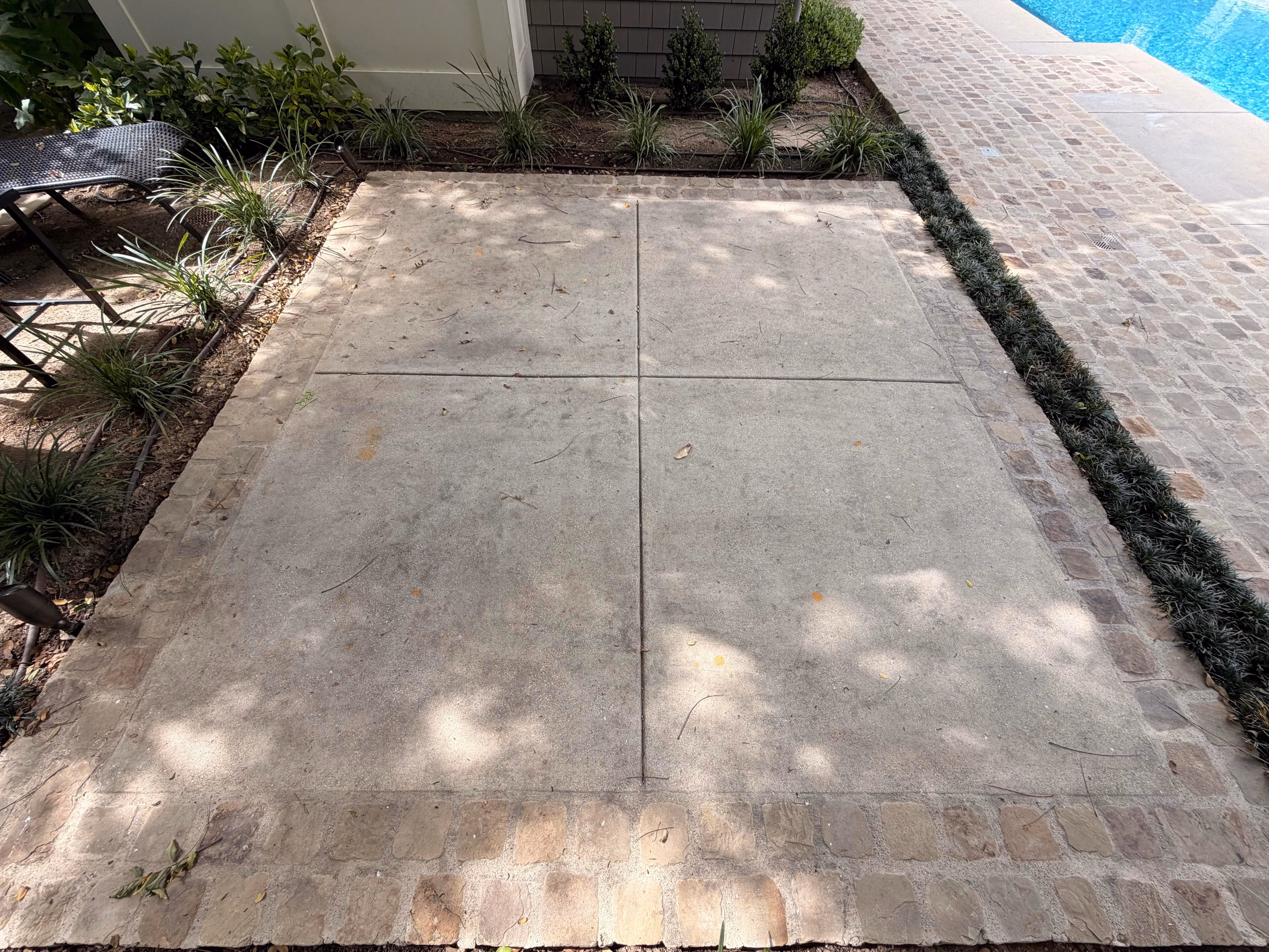 Dirty concrete patio before pressure washing in Pasadena
