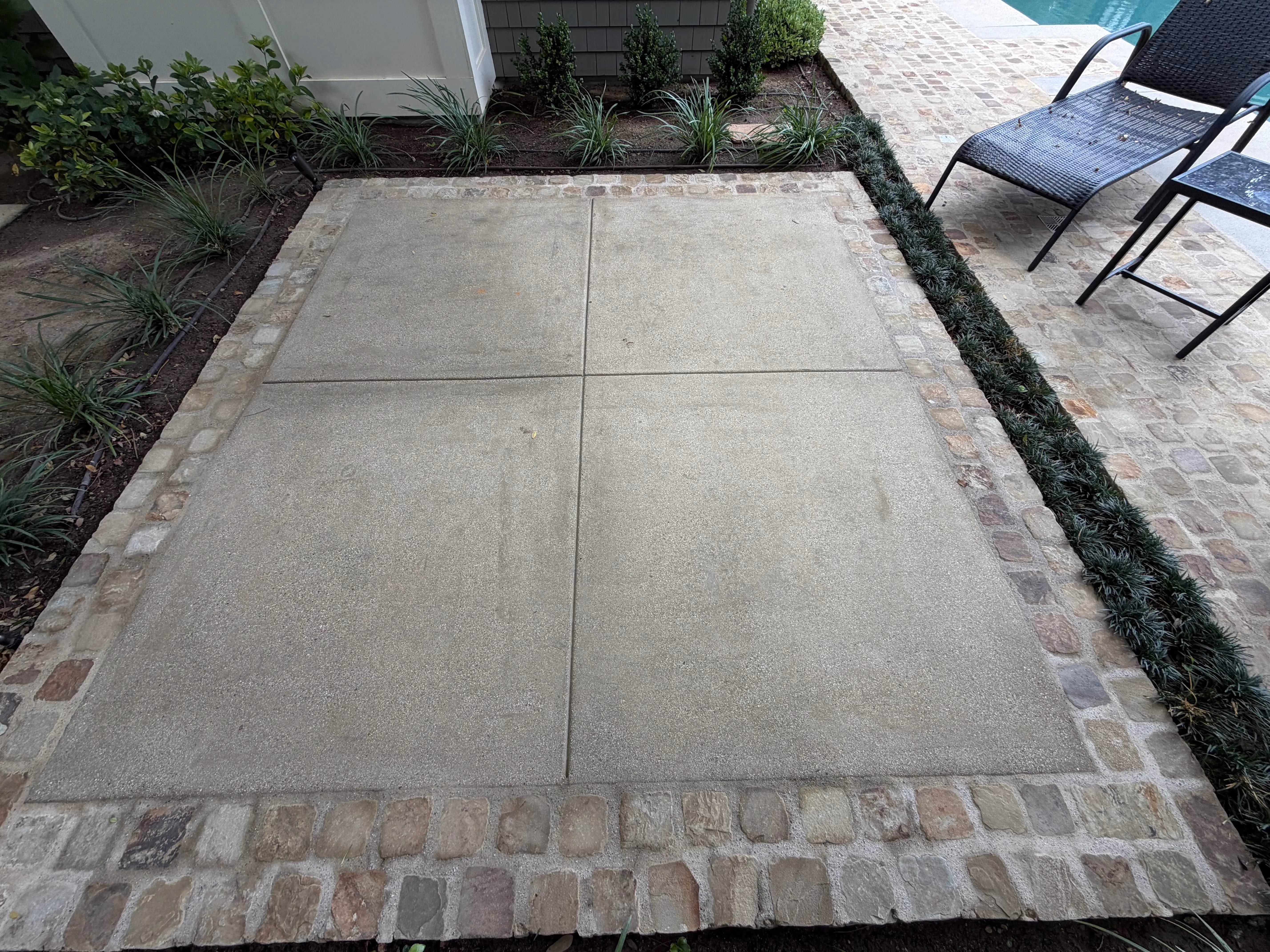 Clean concrete patio after pressure washing by Rexterior in Pasadena
